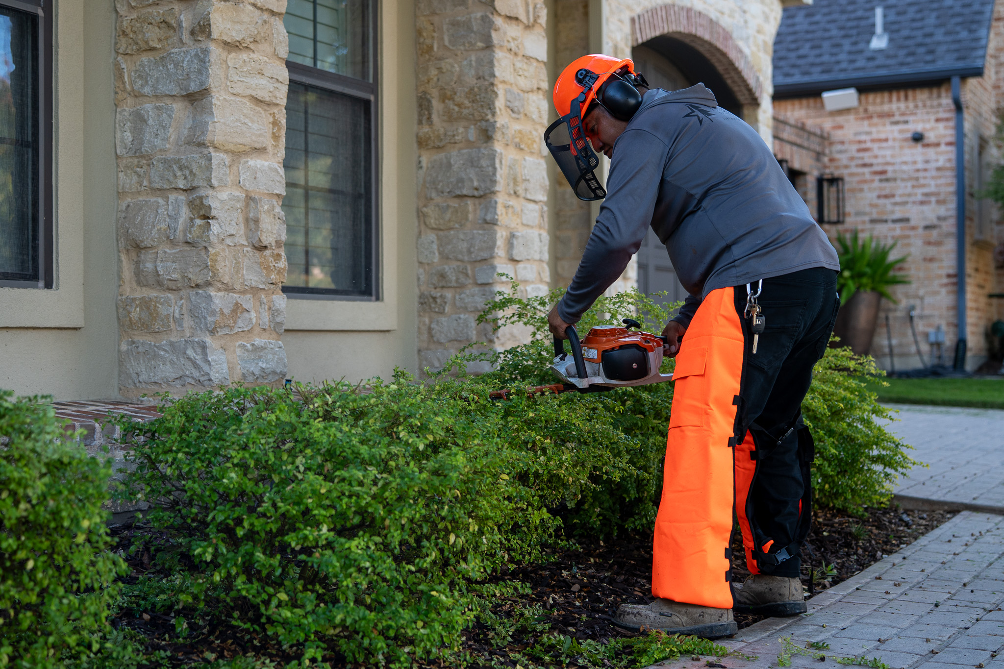 True Star crew trimming shrubs at community
